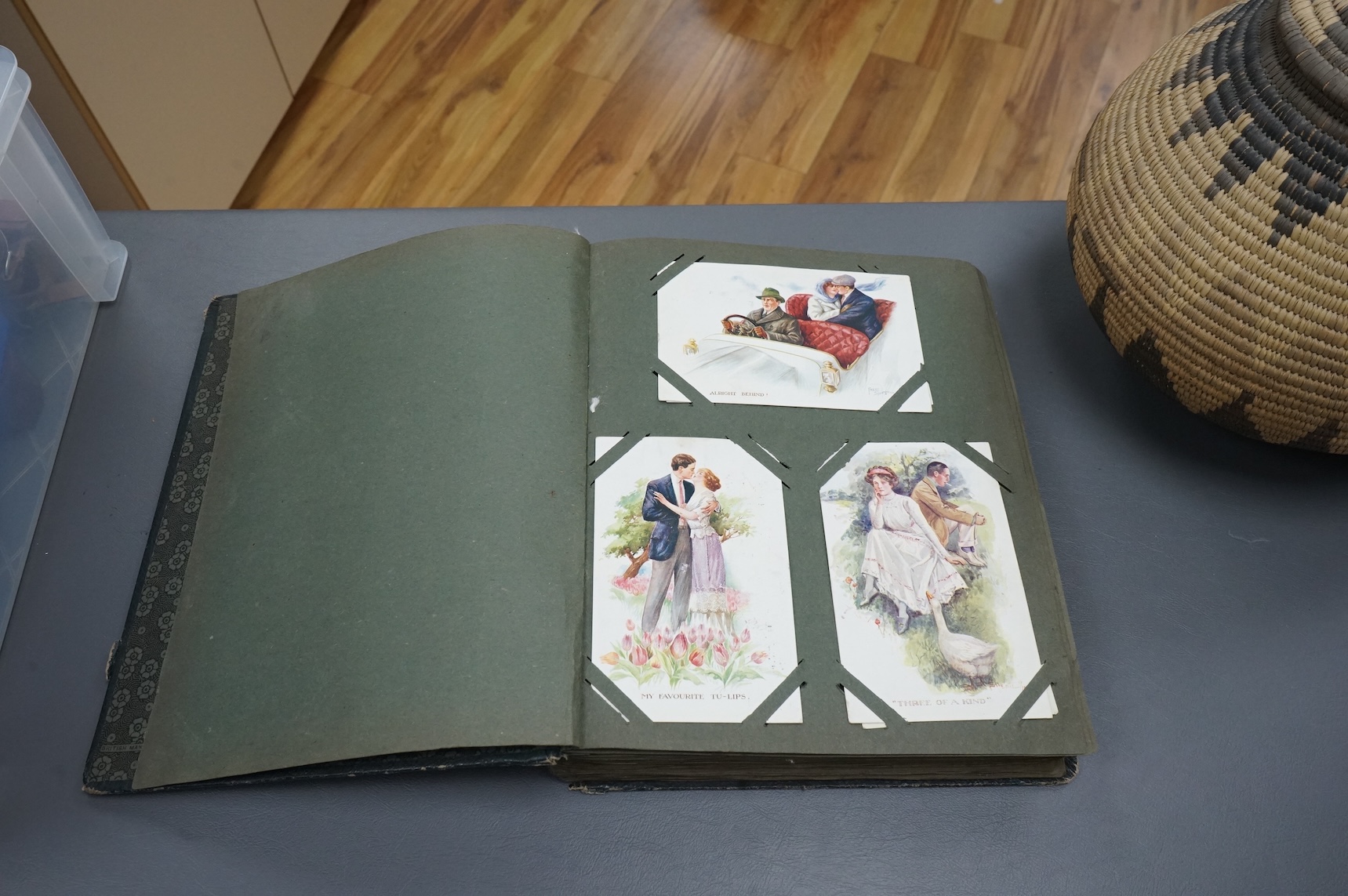 A postcard album containing early 20th century postcards, Gladys Cooper, comics, some photographs